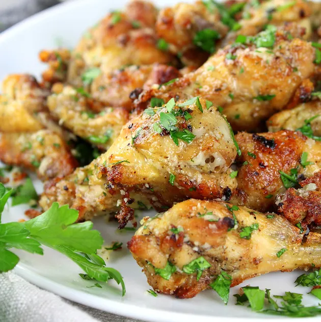 Partial plate of garlic parmesan wings