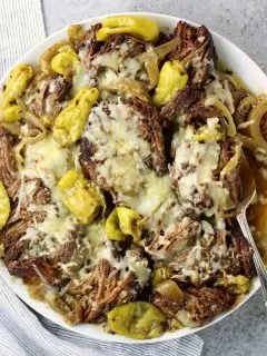 platter of italian beef with melted cheese