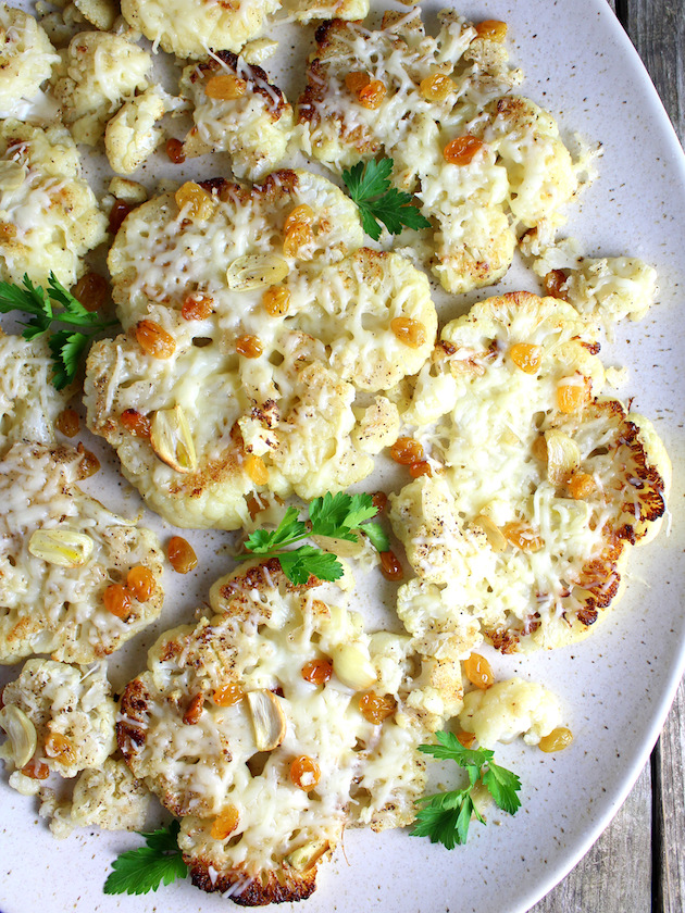 Close up partial platter of Roasted Cauliflower with Asiago and Golden Raisins