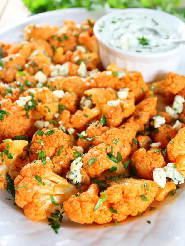 Low Carb Buffalo Cauliflower in a platter with blue cheese sauce
