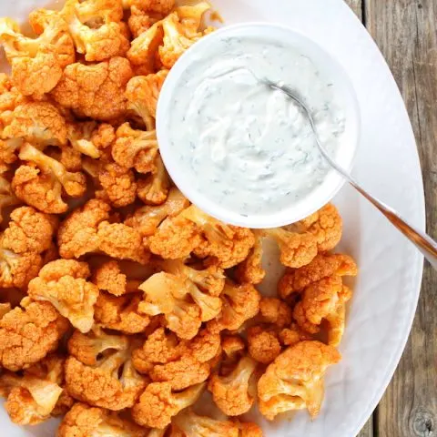 Partial platter of buffalo cauliflower with blue cheese