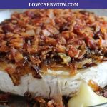 eye level close up baked brie with bacon and onions