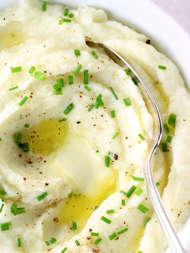 close up bowl of keto low carb mashed cauliflower with melted butter 