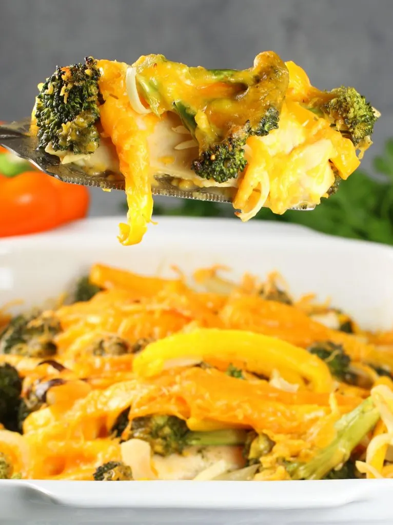 Spatula holding Chicken Casserole with bell peppers, broccoli, and cheese 
