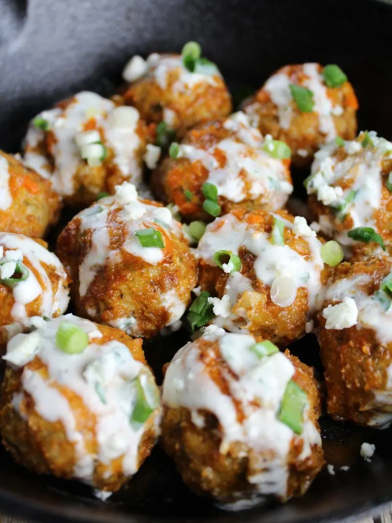 buffalo chicken meatballs with blue cheese sauce in skillet